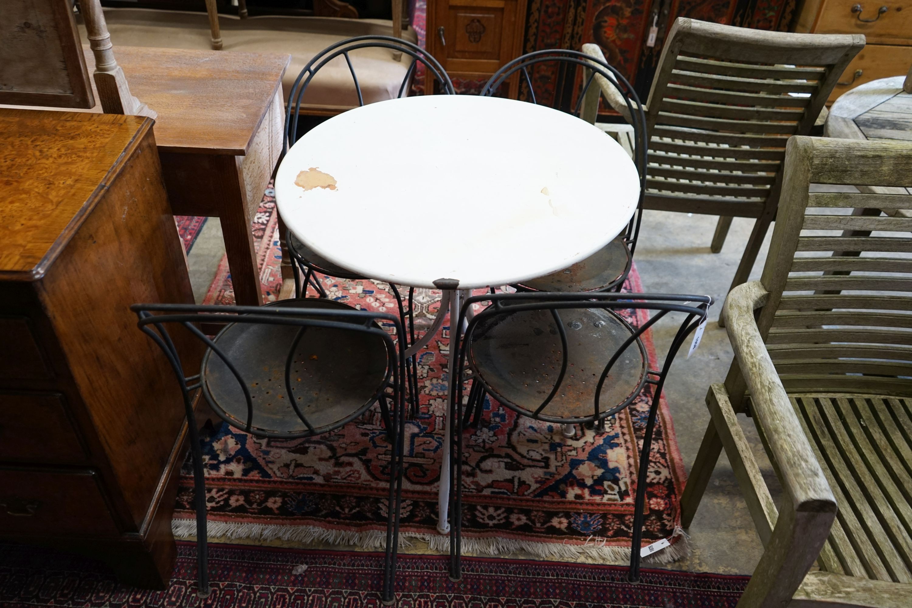 A circular metal garden table, diameter 70cm, height 76cm and four chairs
